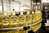 A line of yellow bottles moving down a conveyor belt