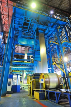 A Steel Mill with long, sturdy, blue metal bars and stairs