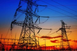 an engineering substation in front of a bright sunset