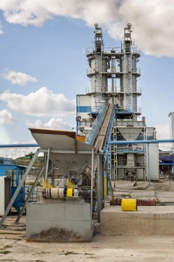 large industrial machine in use at an outdoor sugar refinery.